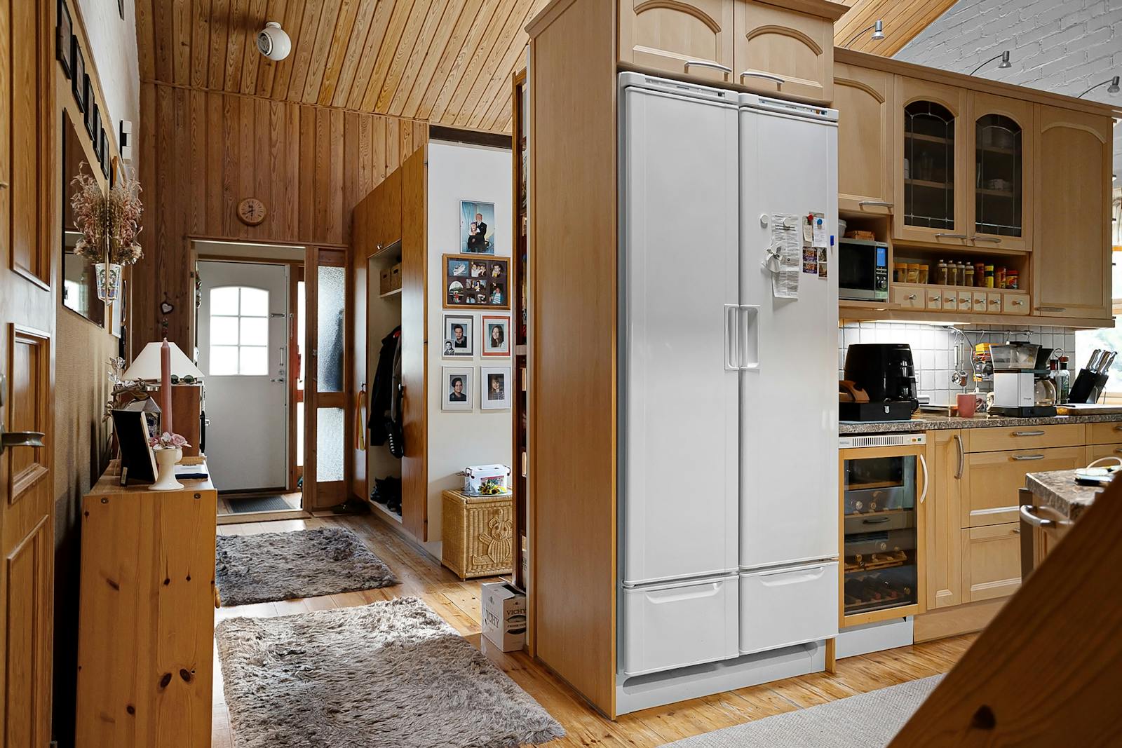 A kitchen with a refrigerator and a stove