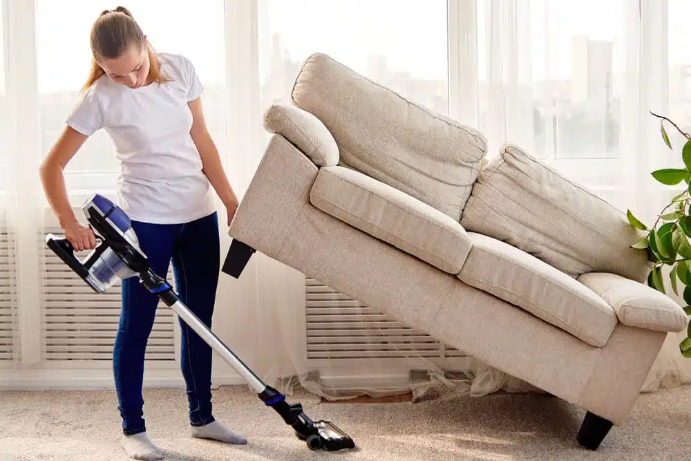Cleaning hard to clean areas under furniture using a Vacuum Cleaner