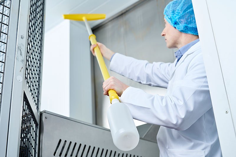 Close-up of cleaning hard to clean areas like top floor with scrubbing brush
