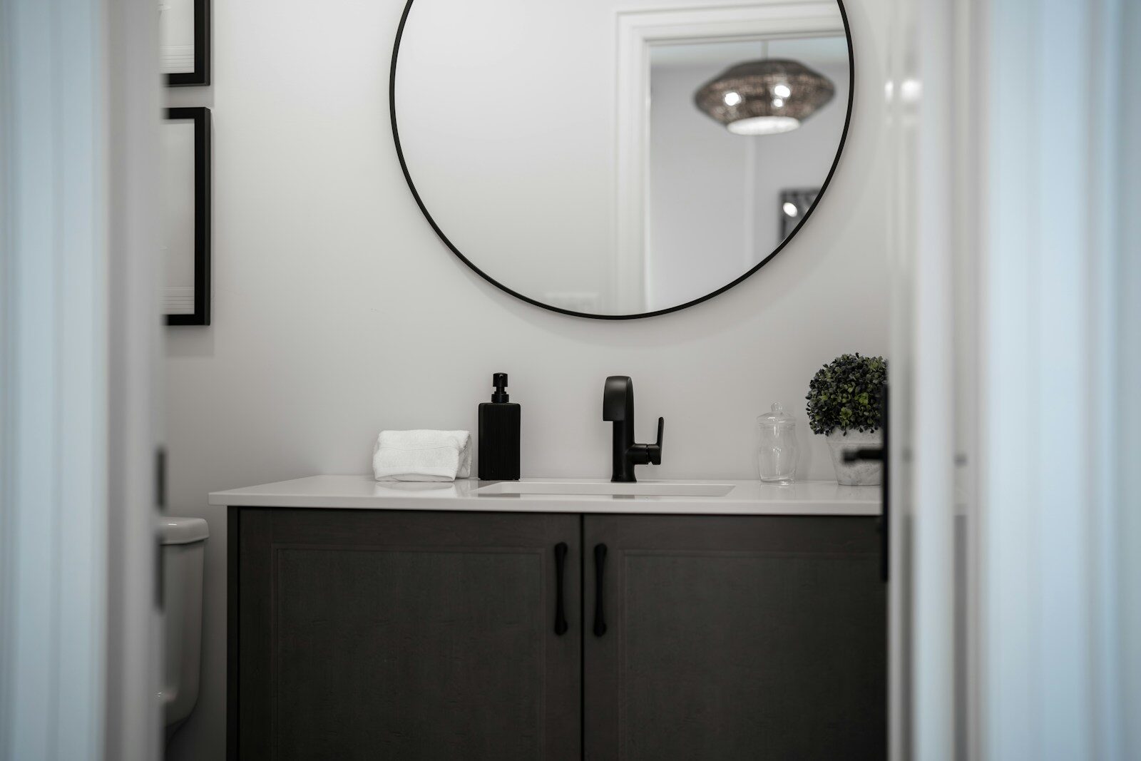 Modern bathroom vanity with a round mirror above