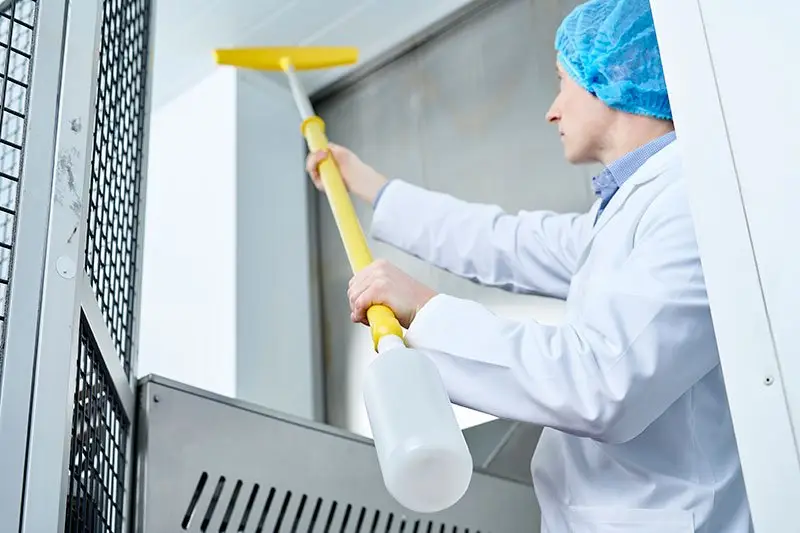 Close-up of cleaning hard to clean areas like top floor with scrubbing brush